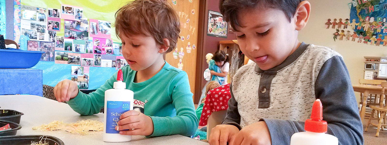 Two children doing crafts in a colorful bright classroom